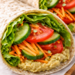 Healthy fast food classic veggie wrap with fresh vegetables and hummus