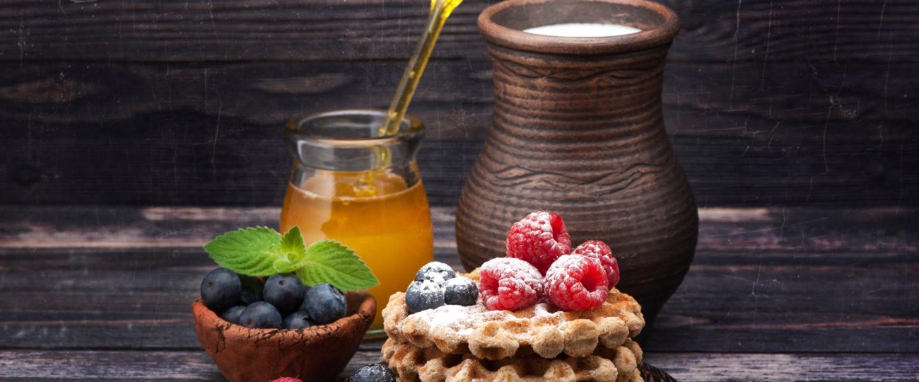 Waffles with berries, honey and milk. Healthy Breakfast
