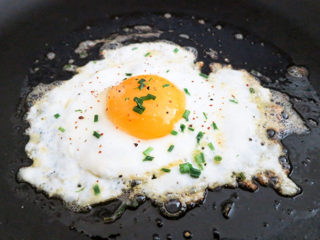 Perfect fried egg with golden edges and runny yolk