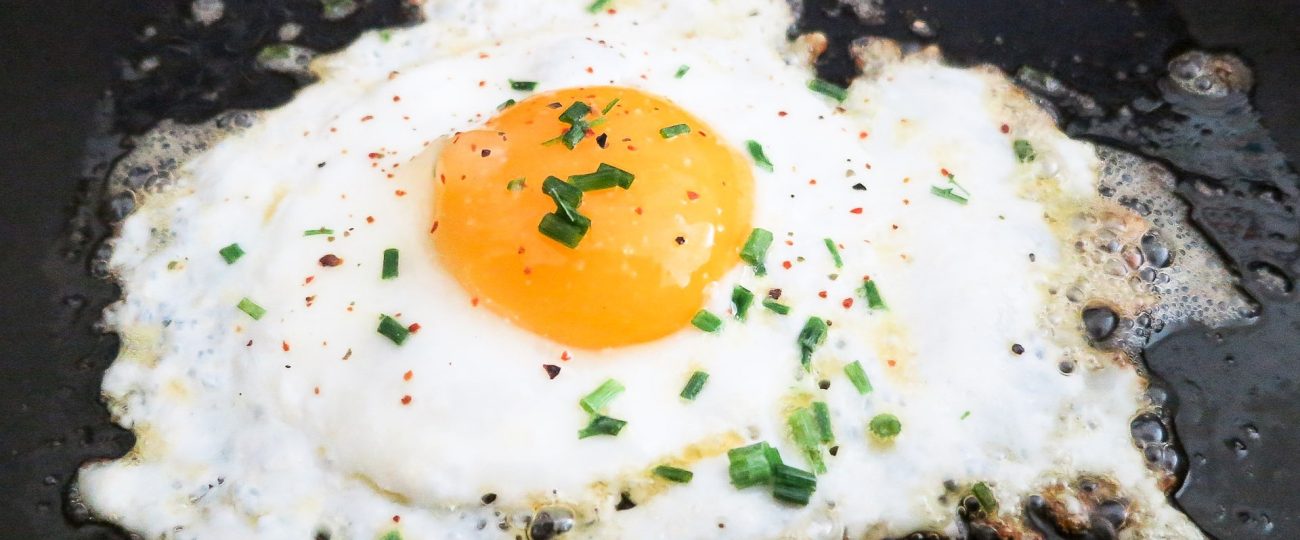 Perfect fried egg with golden edges and runny yolk