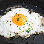 Perfect fried egg with golden edges and runny yolk